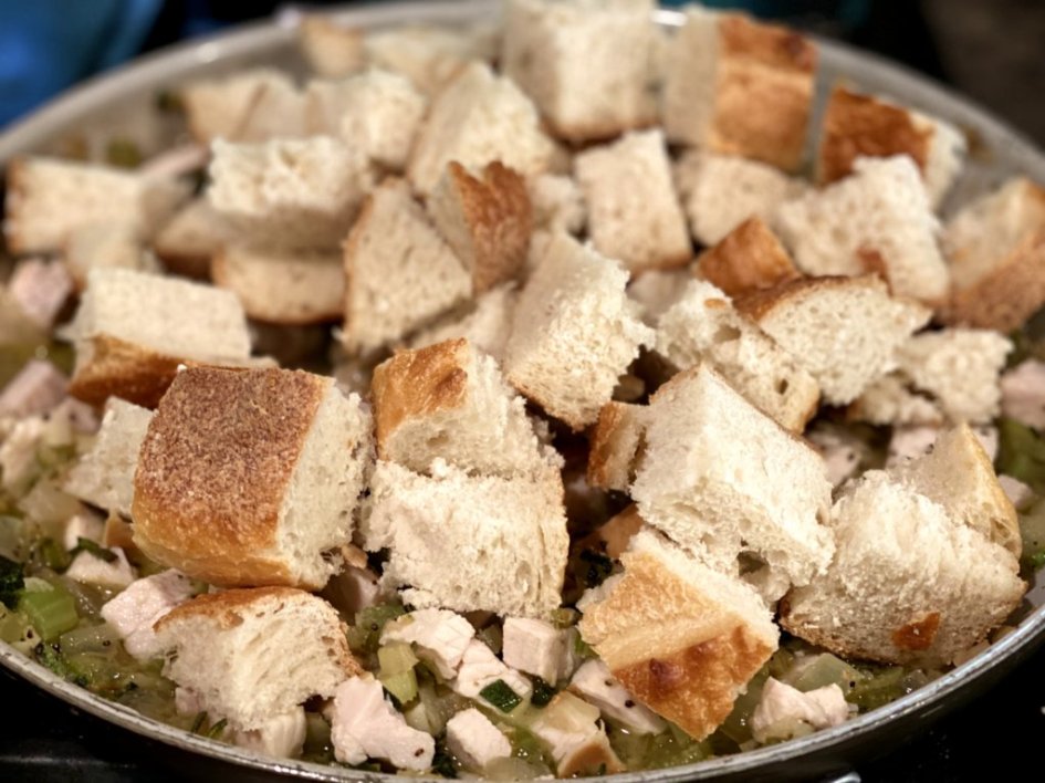 Adding sourdough cubes to the skillet 
