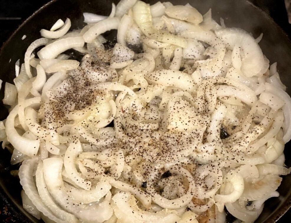 saute onions in a cast-iron skillet with butter and olive oil with salt and pepper in a cast-iron skillet. 