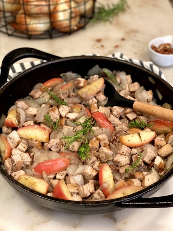Turkey Skillet with Apples and Sweet Onions with pecans in a black cast-iron skillet