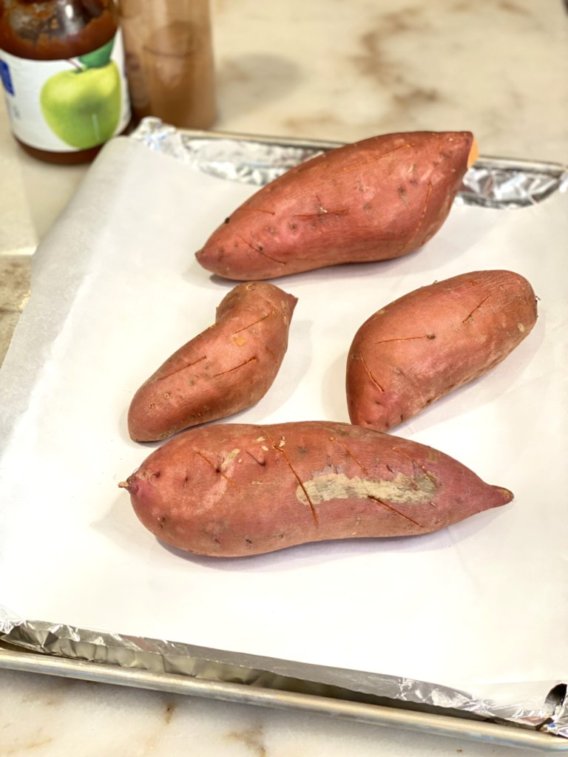 raw sweet potatoes readt to bake in the oven.