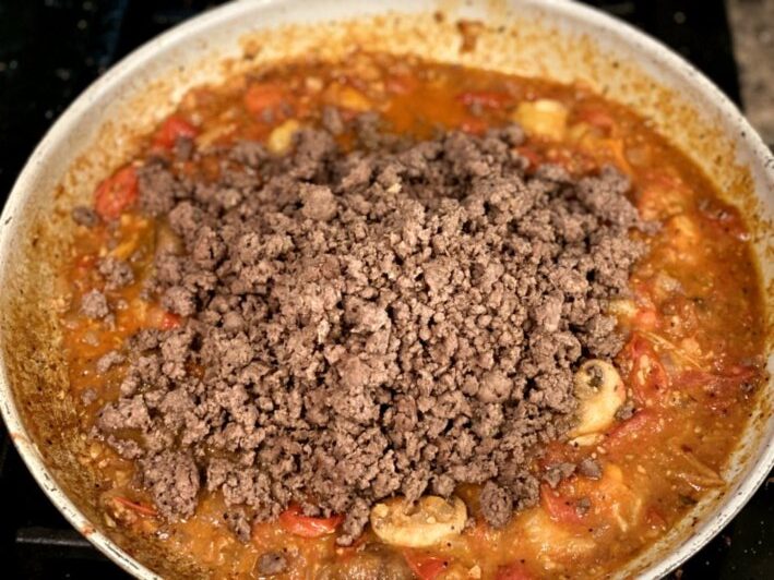 cooked ground beef mixed into the tomato sauce. 