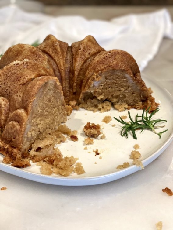 cutting slices into a bundt cake on a white platter. 